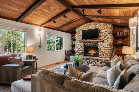 Cozy living area with comfortable seating, a fireplace, and a TV for relaxing nights in.