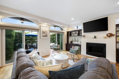 Cozy living room with a TV and seamless access to the balcony.