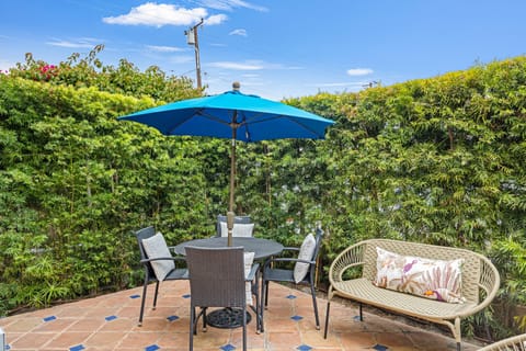 Patio featuring an outdoor dining table and additional seating