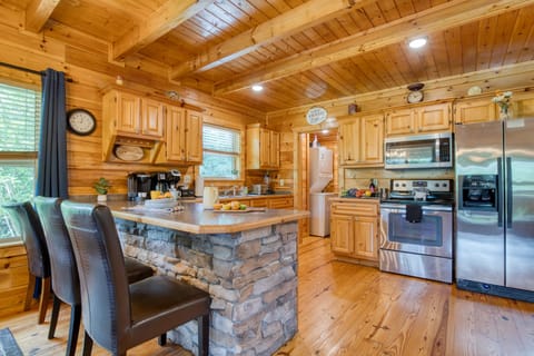 Spacious kitchen with wood cabinetry and stainless steel appliances.