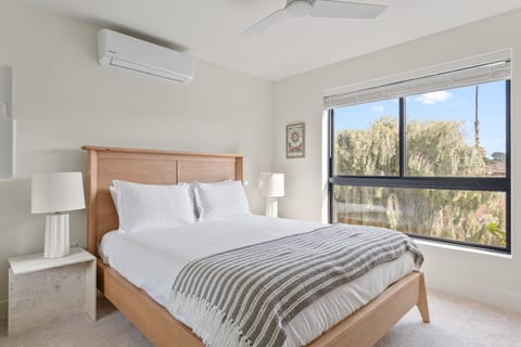 Bedroom 2 features a queen bed, TV and an ensuite bathroom.