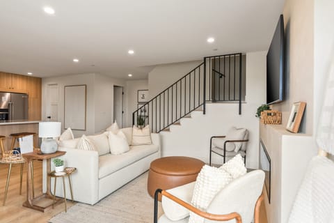 Inviting living room with sleeper sofa, a fireplace, and TV—perfect for unwinding after a day of adventure.