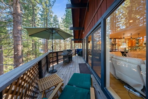 Expansive deck with large glass doors that seamlessly blend indoor and outdoor living spaces.
