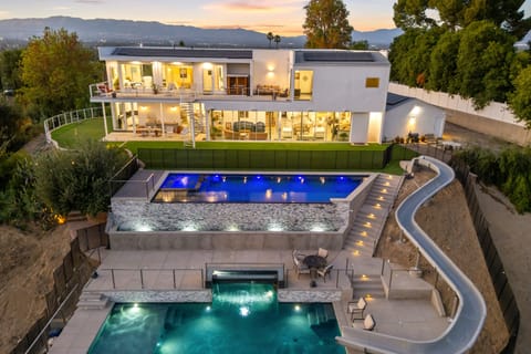 Luxury living redefined: cascading pools, exhilarating slide, and stunning views.