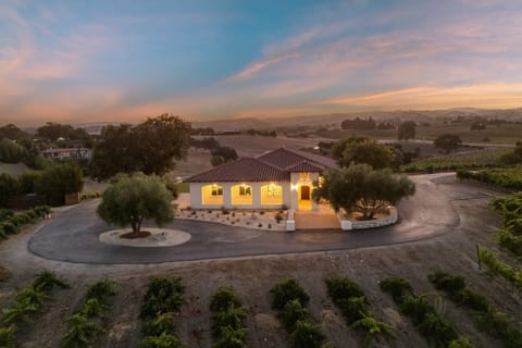 Stunning twilight exterior of the home with vineyard view.