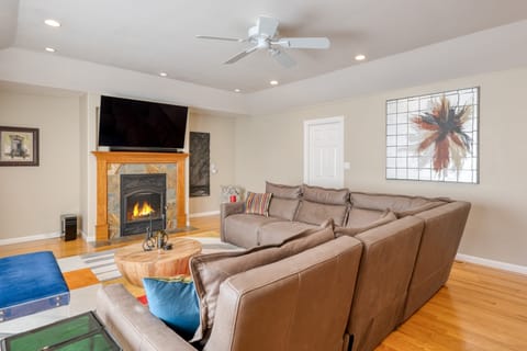 Gather and unwind—spacious living room with a cozy fireplace and plush seating for ultimate comfort.