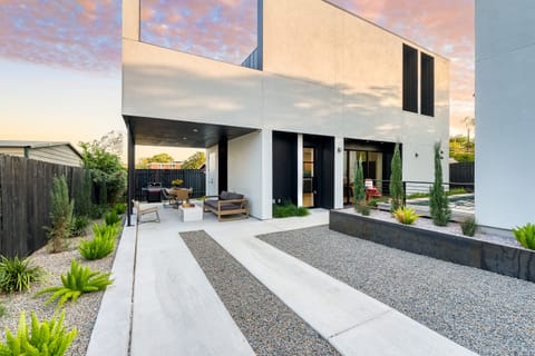 Modern home with a sleek, minimalist exterior, featuring a private backyard with a plunge pool.