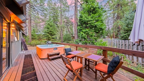Spacious outdoor deck with comfortable lounge seating and a hot tub.