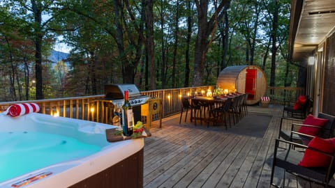 Escape to serenity with our dining space, sauna, and hot tub nestled among the trees.