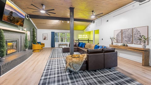 Enjoy fun and warmth with a foosball table and an inviting indoor fireplace in the heart of the living room.