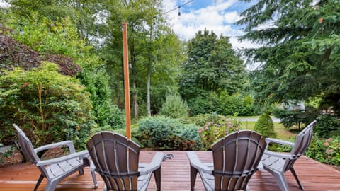 Outdoor deck with seating among trees.