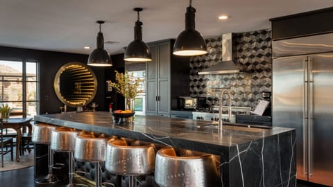 Luxury chef's kitchen with barstool seating.