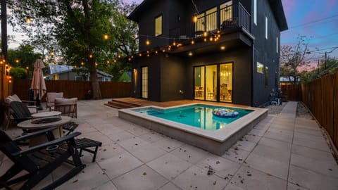 Backyard view with plunge pool, BBQ grill, and seating.