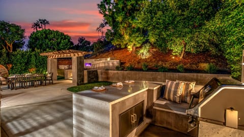 Private backyard with built-in grill, outdoor dining, and lounge.