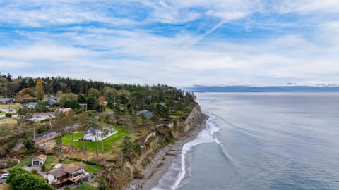 Aerial view showing home and coastline below.