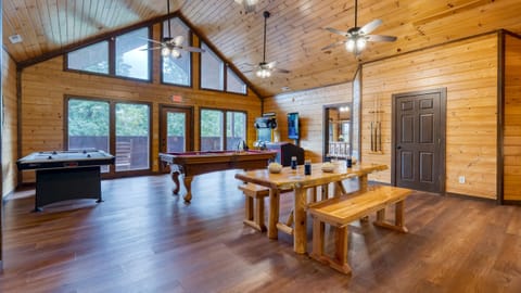 Game room with pool table, air hockey & arcade games.