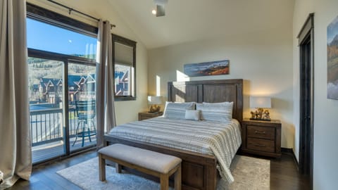 The primary bedroom features a king bed, TV, balcony, and private bathroom.