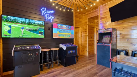 Game room fun with a golf simulator and multiple arcade games.
