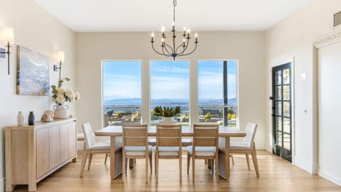 Dining area with a chandelier and views from the window.