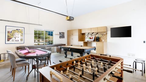 Game room TV, poker table, foosball, and pool table.