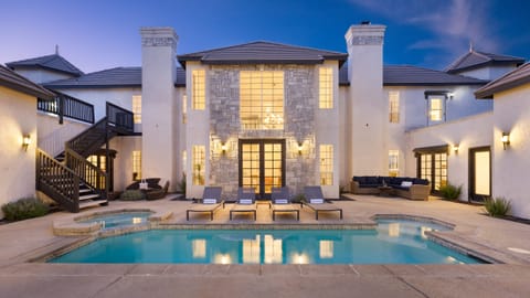 Pool and spa area with sun loungers.