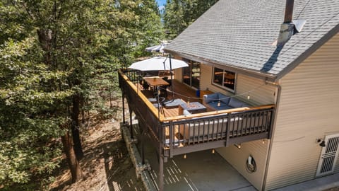 Spacious forest-view deck with firepit and outdoor dining — your private mountain retreat among the trees.