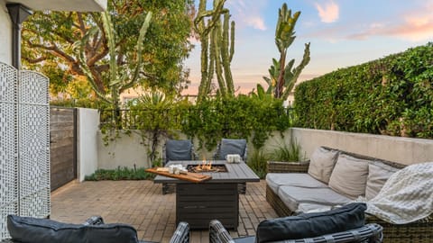 Unit 2: Patio lounge with cushioned seating and firepit.