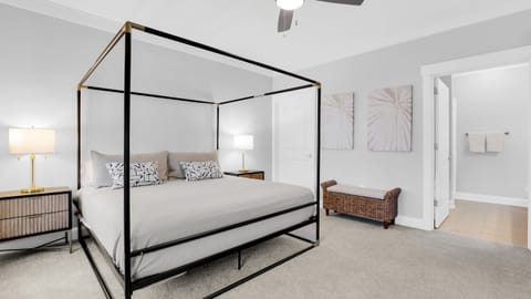 The primary bedroom features a king bed, TV, desk and an ensuite bathroom.