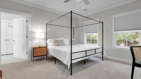 The primary bedroom features a king bed, TV, desk, and an ensuite bathroom.