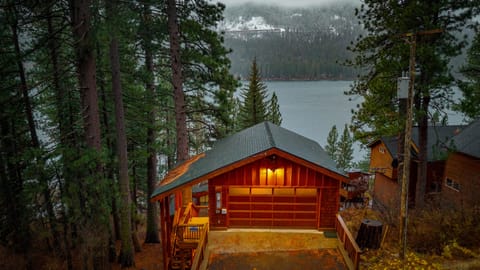 Mountain cabin perched above the lake with serene forest views.