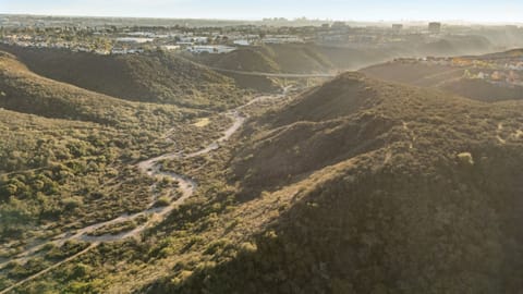 Wide aerial view of the vast canyon and rolling hills surrounding the community.