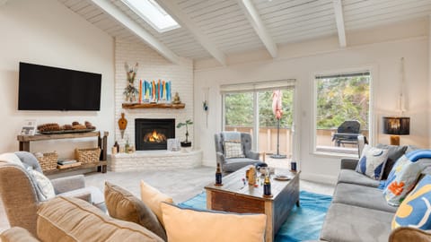 Living room featuring a fireplace, TV, and comfortable seating. (Ski Way)