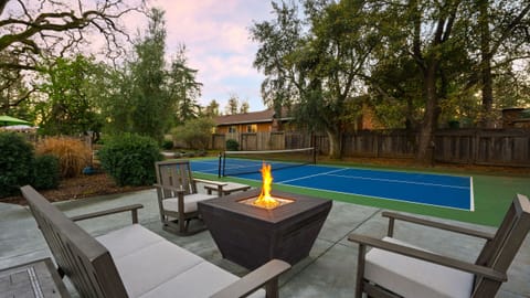 Evenings come alive around the fire pit, with a private pickleball court just steps away.
