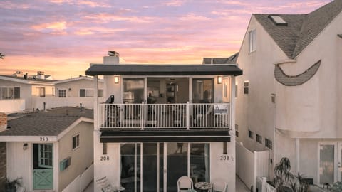 Upper-level unit featuring a private second-floor balcony with outdoor seating and sliding-door access.