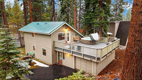 Cozy cabin with spacious deck, hot tub, and forest surroundings.