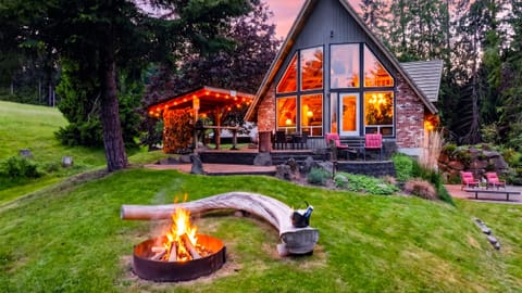 End the day by the firepit as the A-frame glows against a peaceful Whidbey Island sunset.