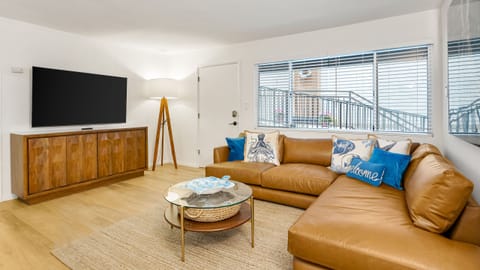 Spacious, sun-drenched living area featuring contemporary finishes and a warm, inviting atmosphere.