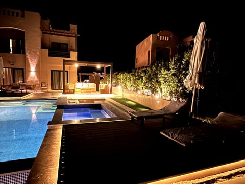 Property building, Patio, Night, Pool view, Swimming pool, sunbed