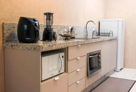 Kitchen or kitchenette, microwave, oven, stove