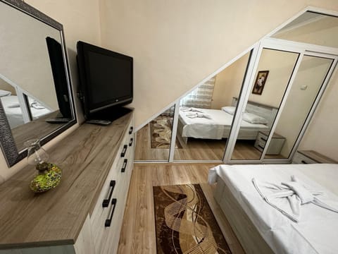 Bed, TV and multimedia, Seating area, Bedroom, towels, wardrobe