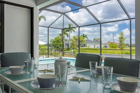 Pool overlooking canal, Outdoor Grilling station - Villa Sand Dollar Siesta House in Cape Coral