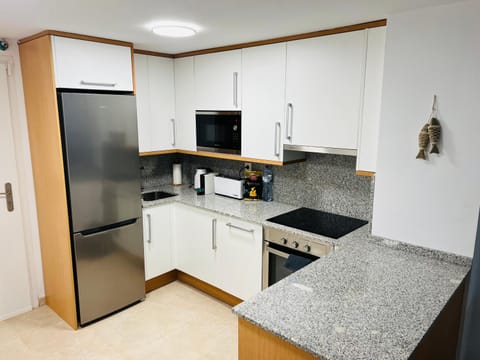 Kitchen or kitchenette, dishwasher, oven, stove