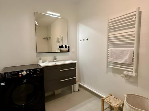 Bathroom, hair dryier, towels, washing machine, dryer