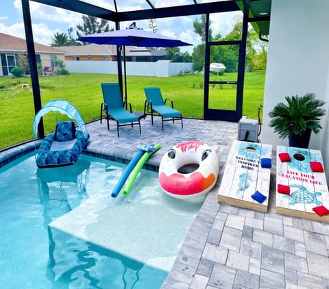 Perfect Oasis Retreat ! 2023 Luxury Built Home, Heated Pool and Games Haus in Cape Coral