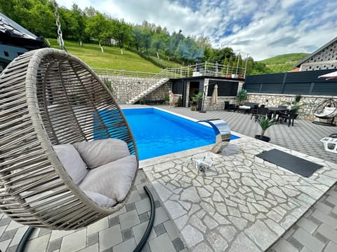 Property building, Patio, Day, Natural landscape, Seating area, Pool view, Swimming pool, sunbed