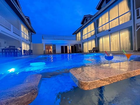 Property building, Patio, Night, Pool view, Swimming pool, Swimming pool, sunbed