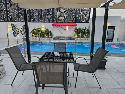 Property building, Patio, Seating area, Pool view, Swimming pool