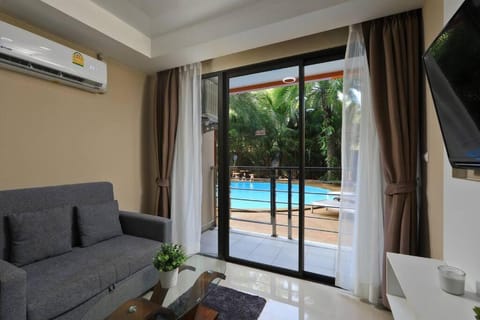 TV and multimedia, Living room, Seating area, Pool view, Swimming pool, sunbed, air conditioner