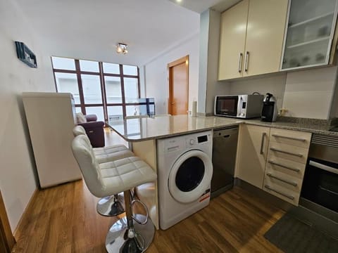 Kitchen or kitchenette, dishwasher, oven, stove, toaster, washing machine