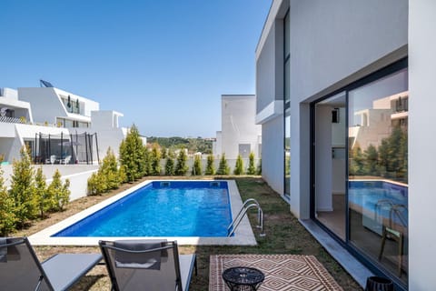 Property building, Patio, Pool view, Swimming pool, sunbed